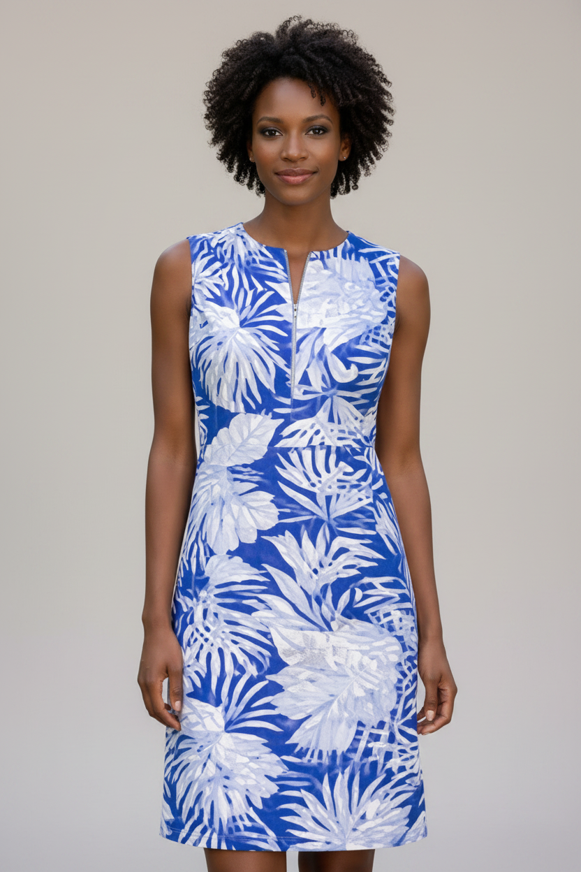 Woman wearing a blue and white floral dress against a plain background