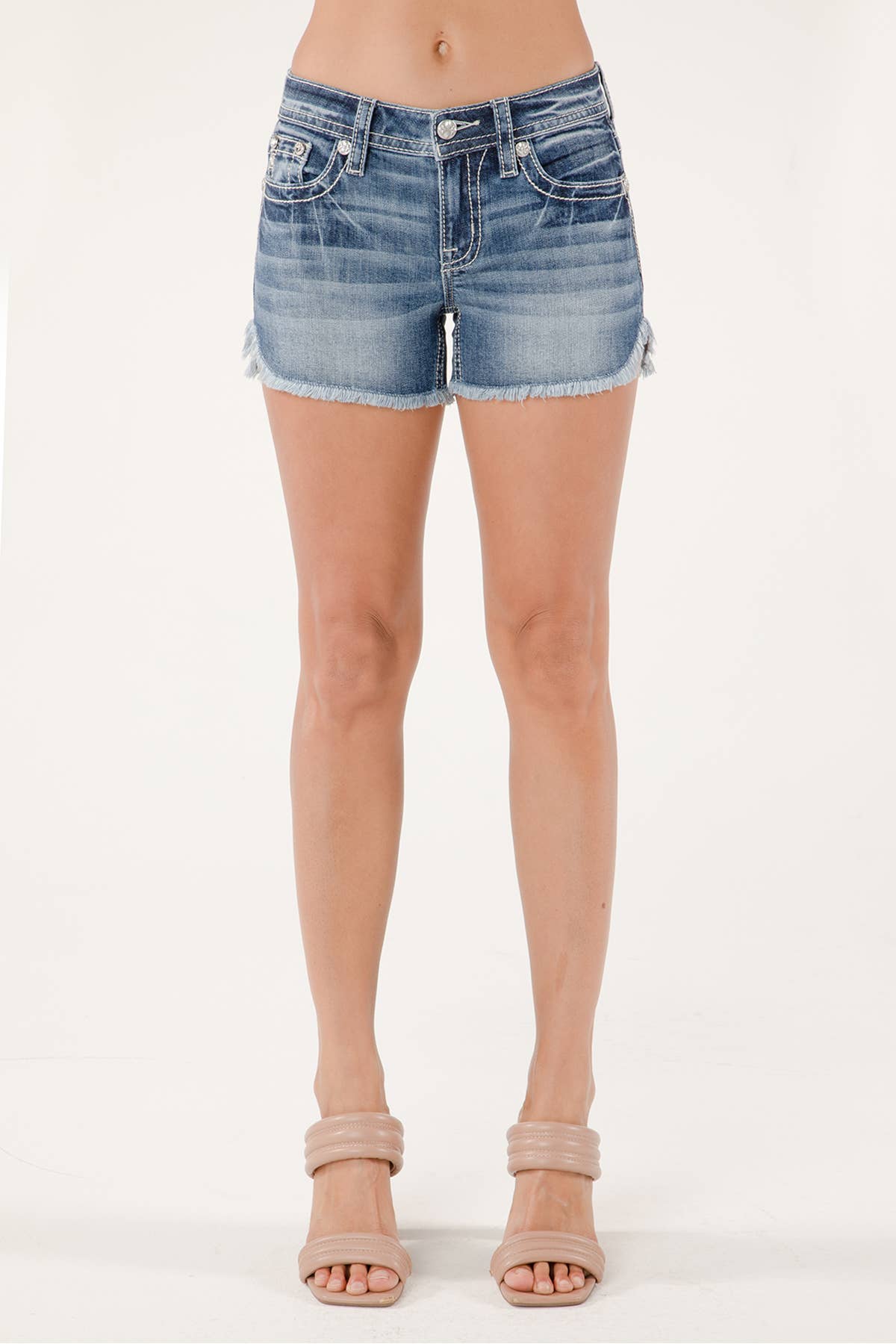 Denim shorts worn by a person on a white background