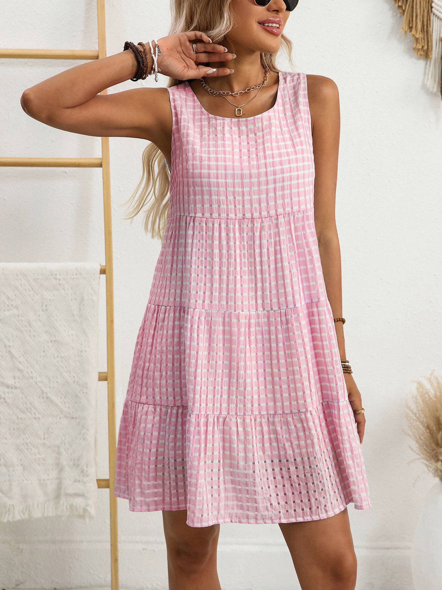 Sleeveless plaid dress by Wholesalesir featuring a classic checkered pattern and a fitted waist on a model.