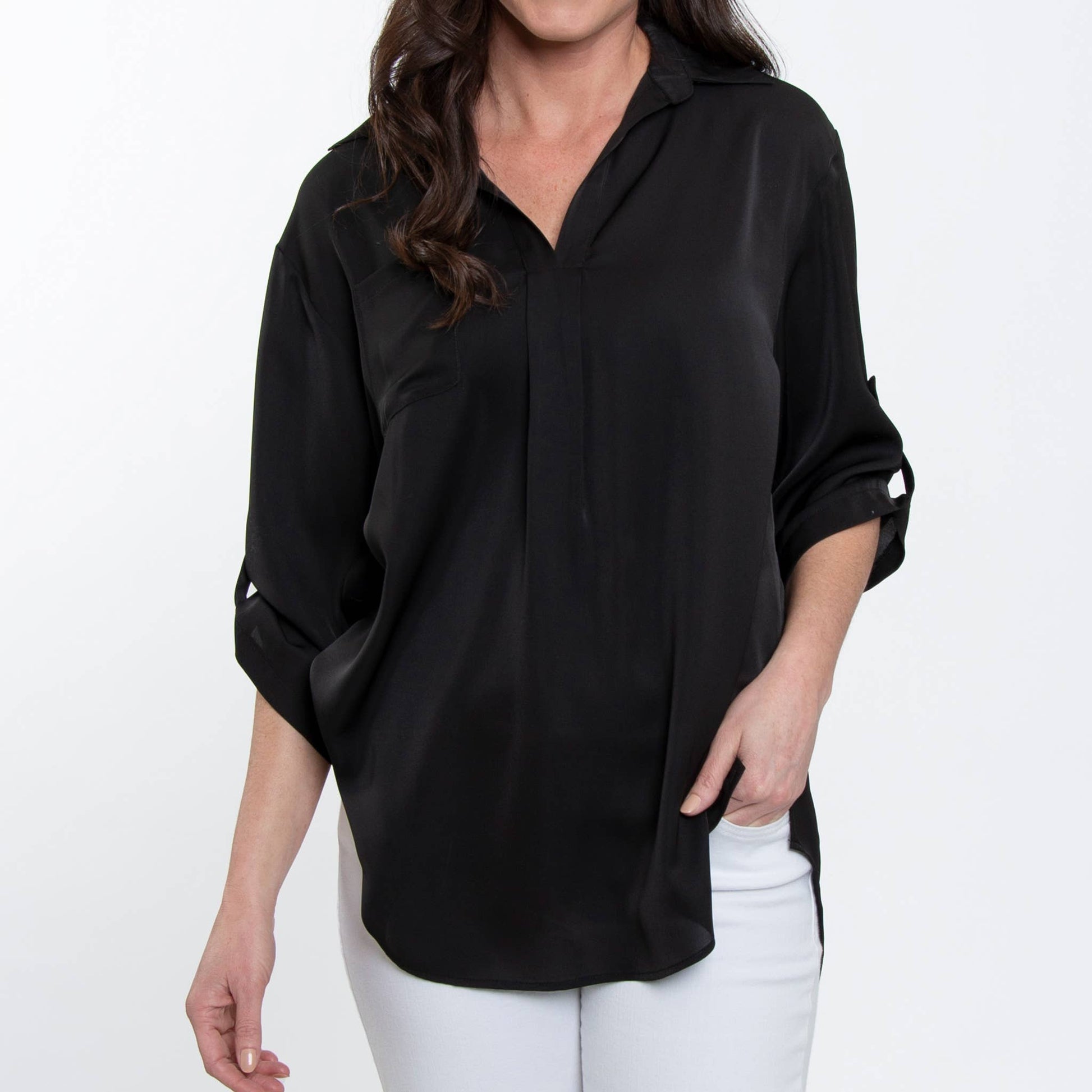 Woman wearing a black shirt and white pants on a white background