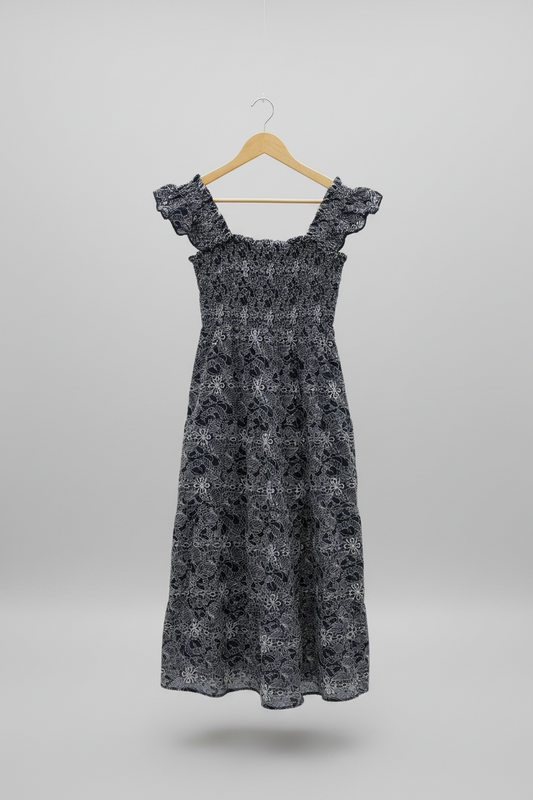 Navy embroidered smocked midi dress from Chic Speak Boutique with detailed embroidery and a fitted, feminine silhouette.
