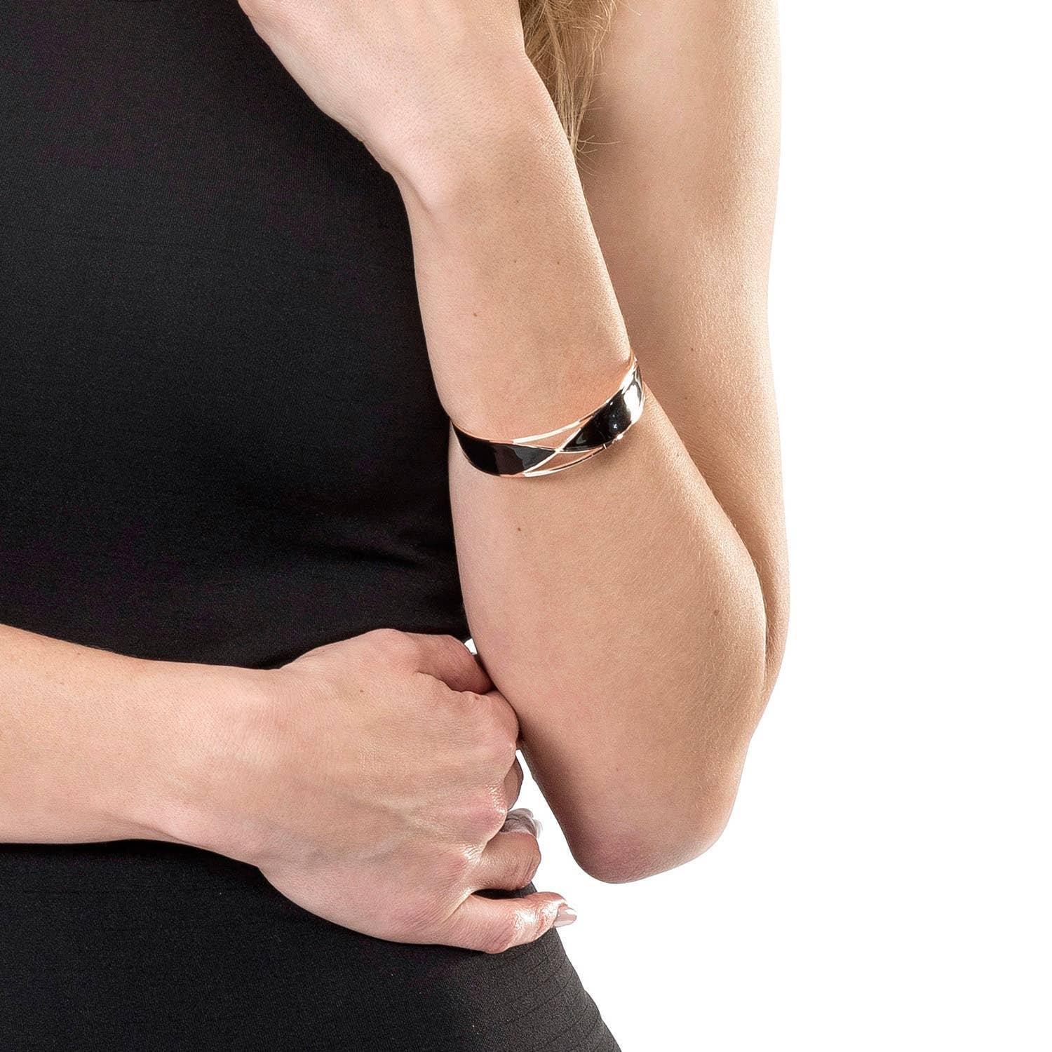 Person wearing a silver bracelet on a plain background