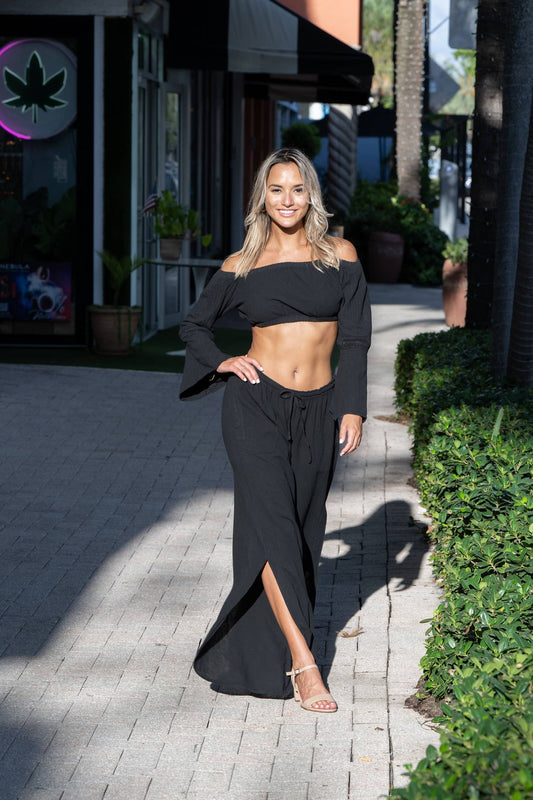 Thai Black Pants by Cotton Natural, featuring a relaxed fit and lightweight fabric, shown in a stylish outdoor setting.