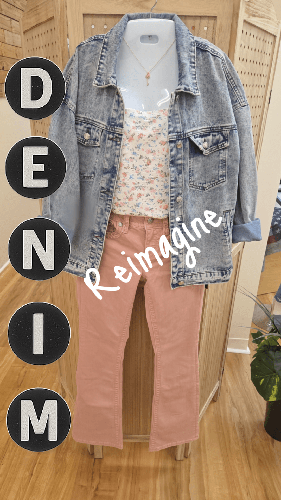 Denim jacket over a floral top and pink pants with 'Reimagine Denim' text.
