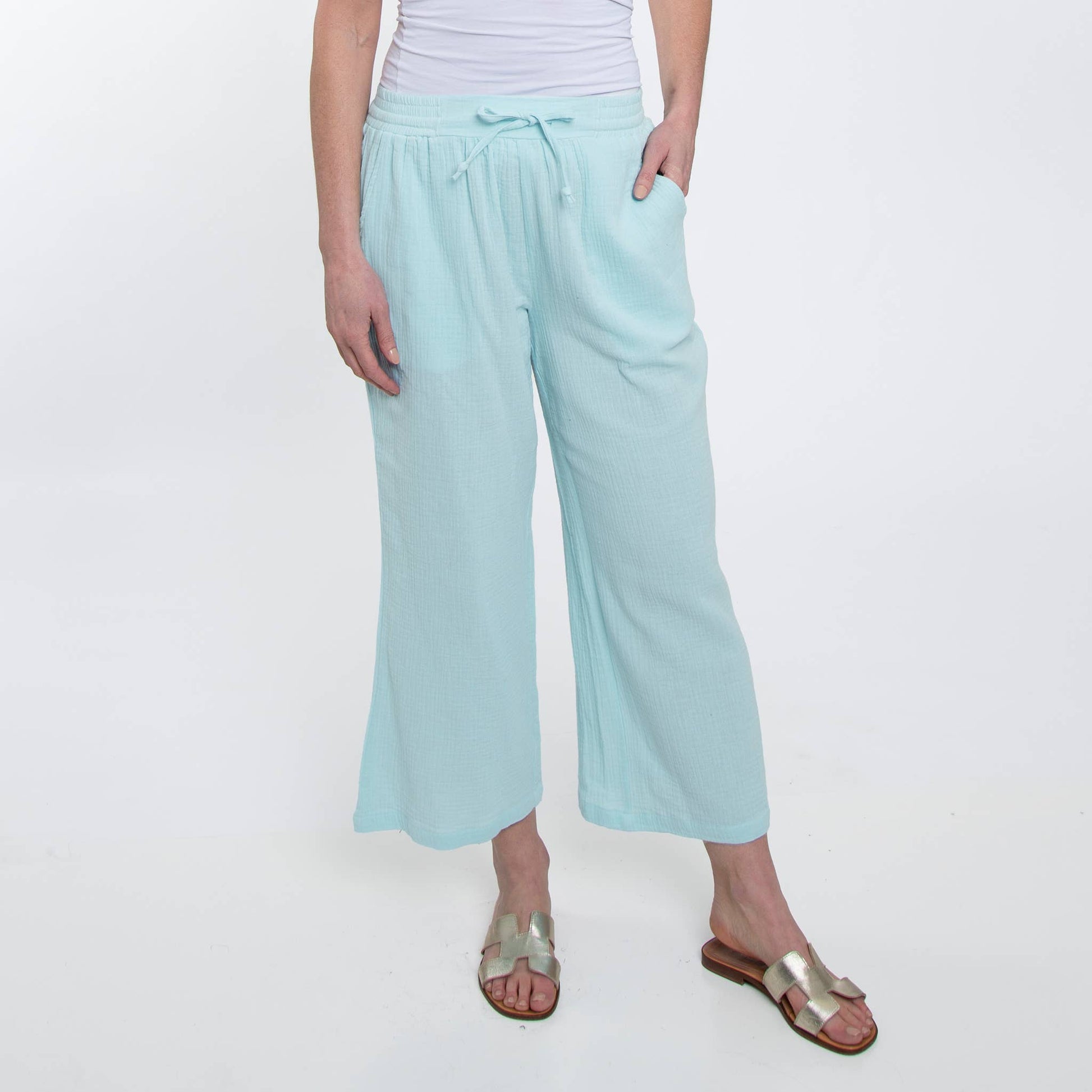 Person wearing light blue pants on a white background