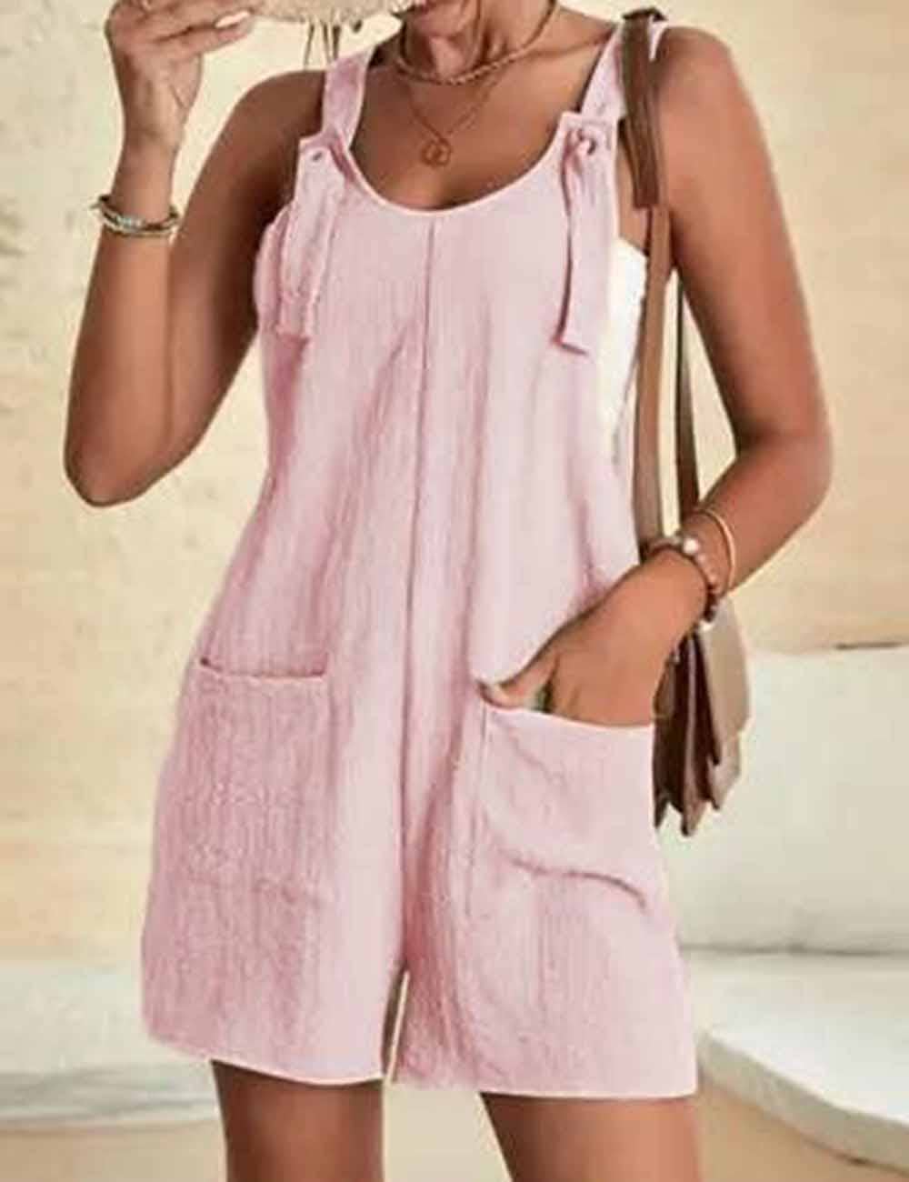 Woman wearing a pink romper with a neutral background