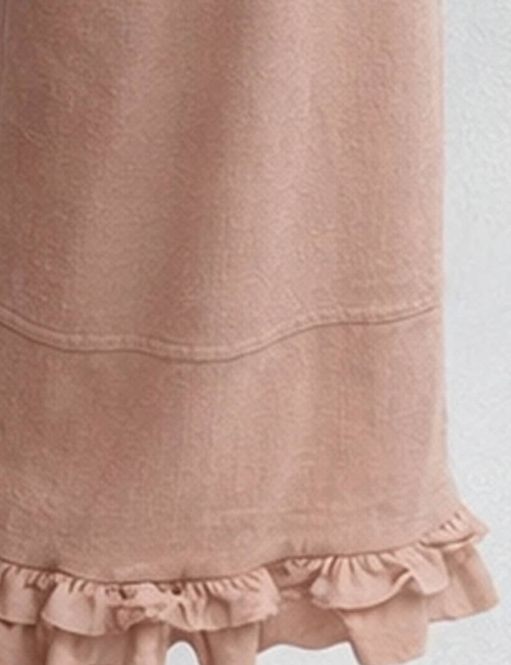 Close-up of a pink skirt with ruffled hem on a white background