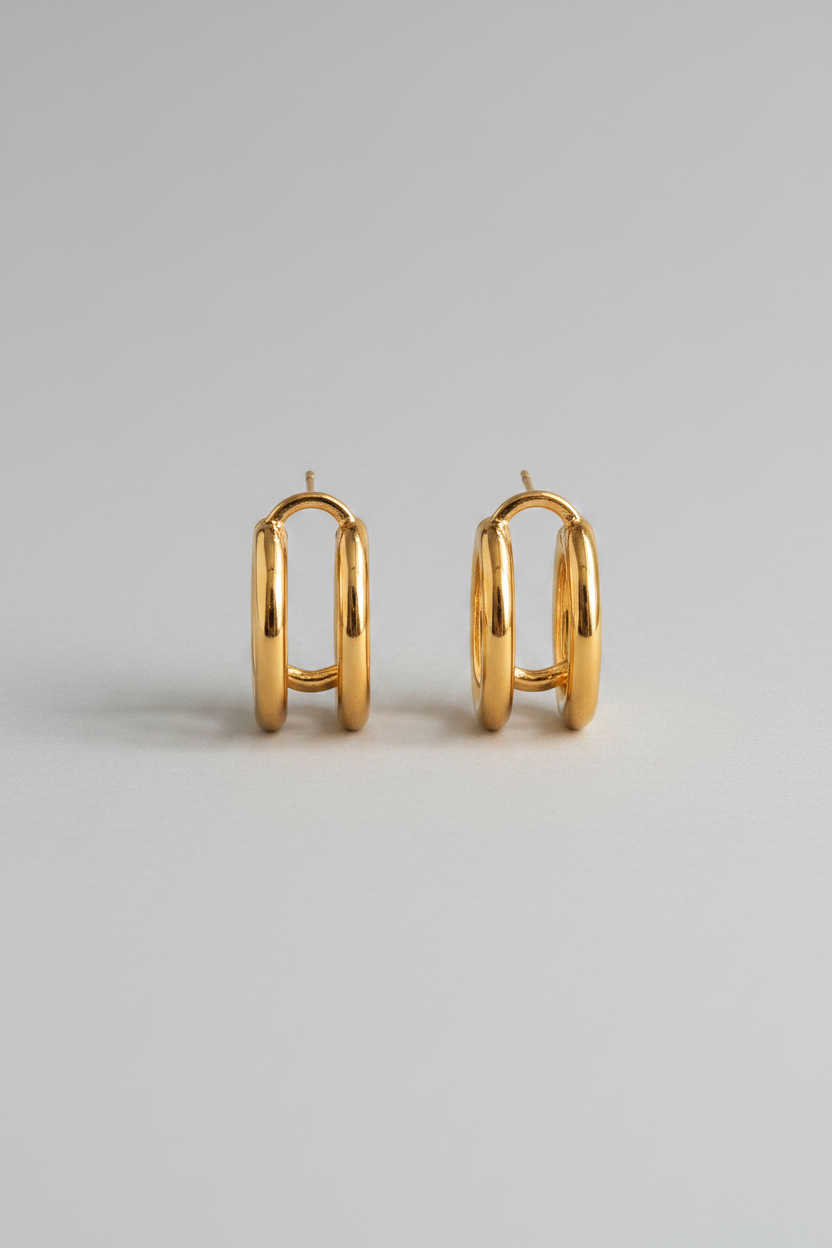 Gold hoop earrings on a light gray background