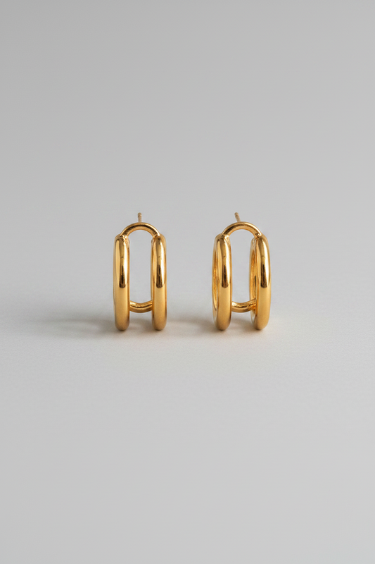 Gold hoop earrings on a light gray background