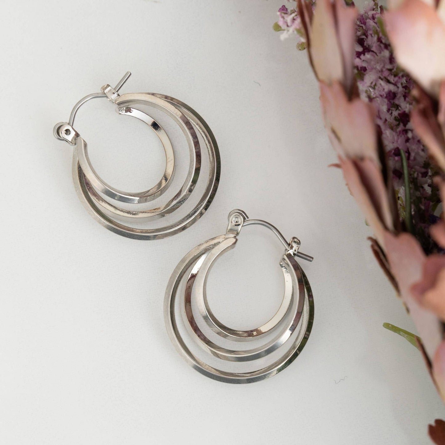 Silver Hoop Earrings featuring a classic multi-hoop design, perfect for elevating any outfit with their stylish charm.