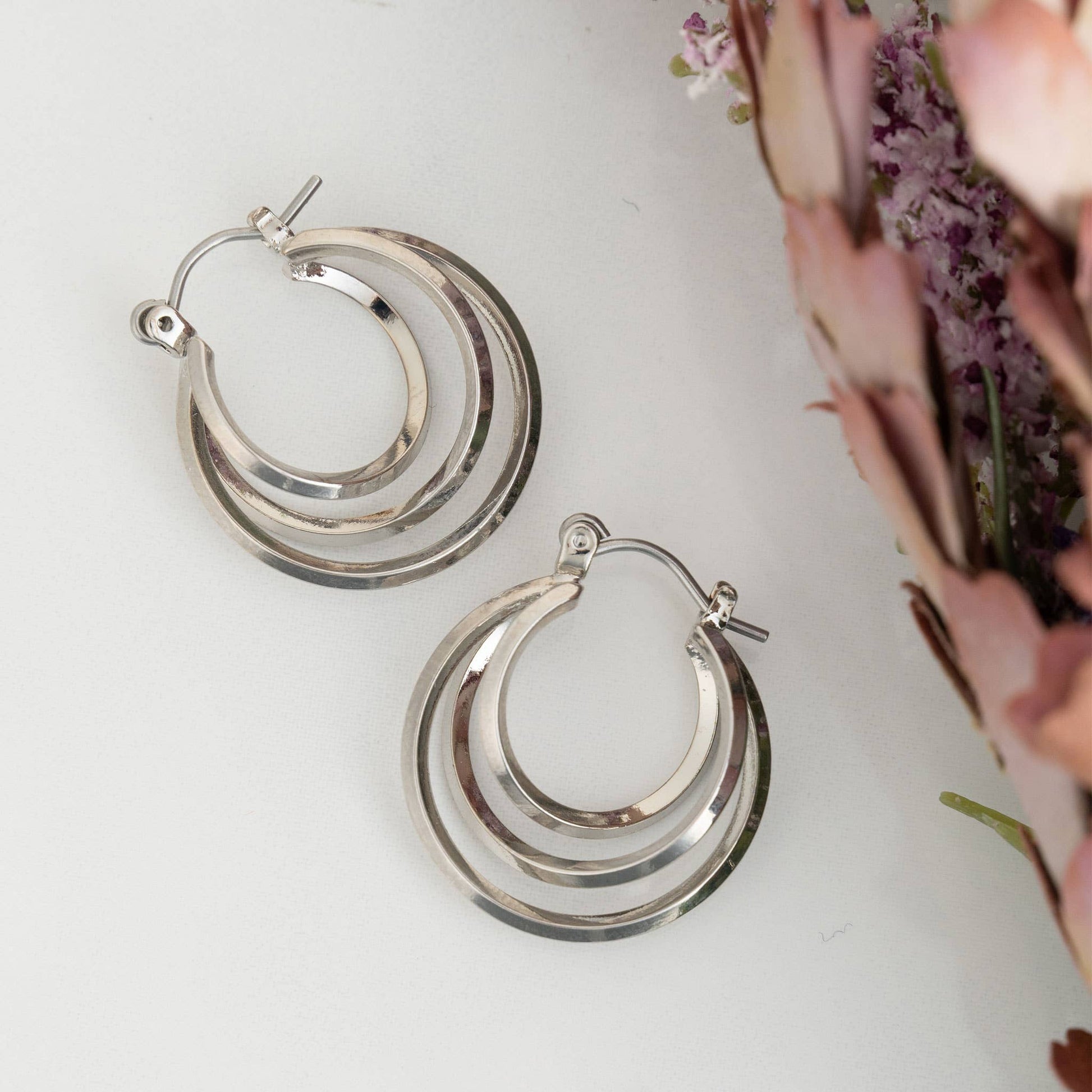 Silver Hoop Earrings featuring a classic multi-hoop design, perfect for elevating any outfit with their stylish charm.