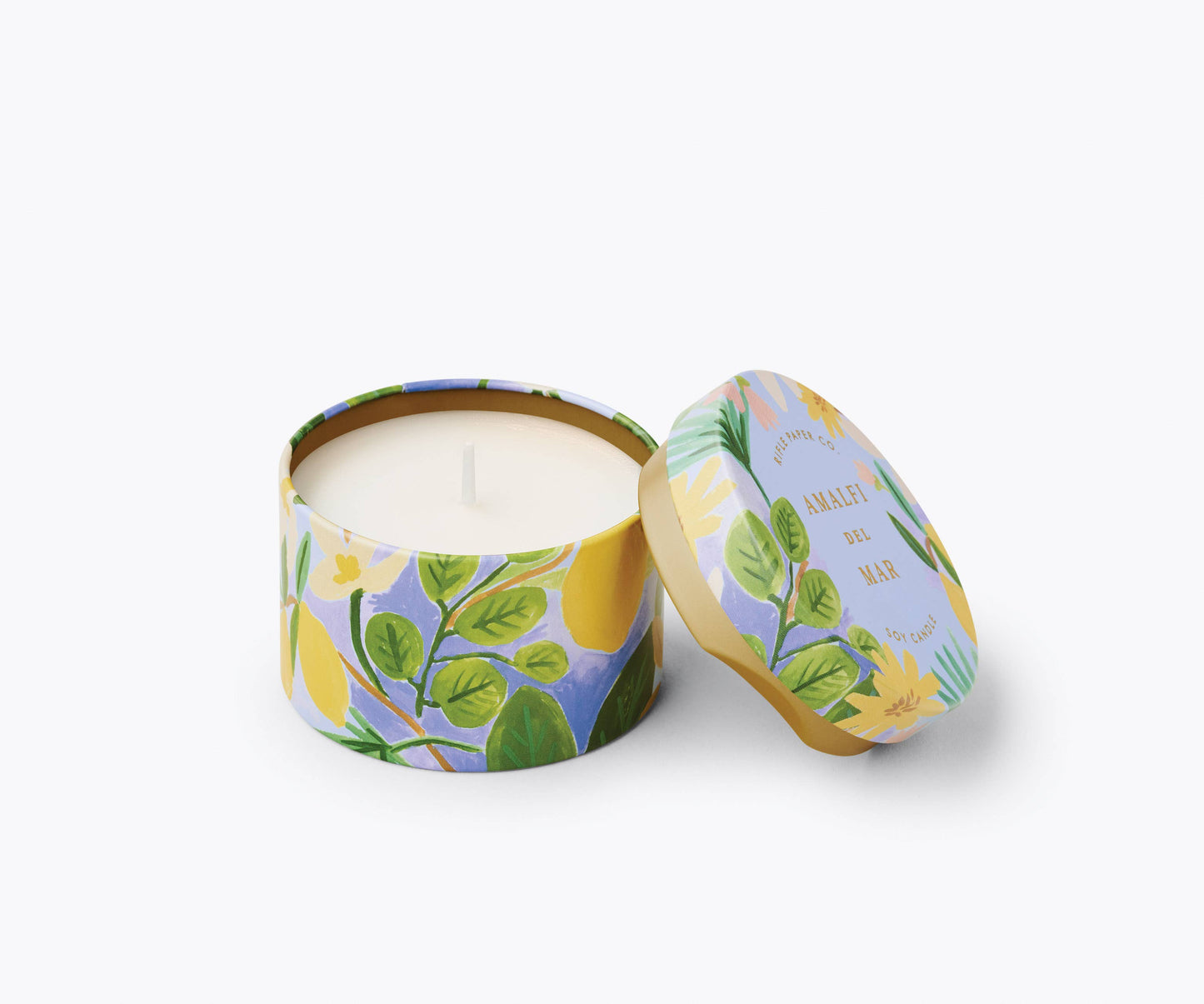 Candle in a floral tin with a matching lid on a white background
