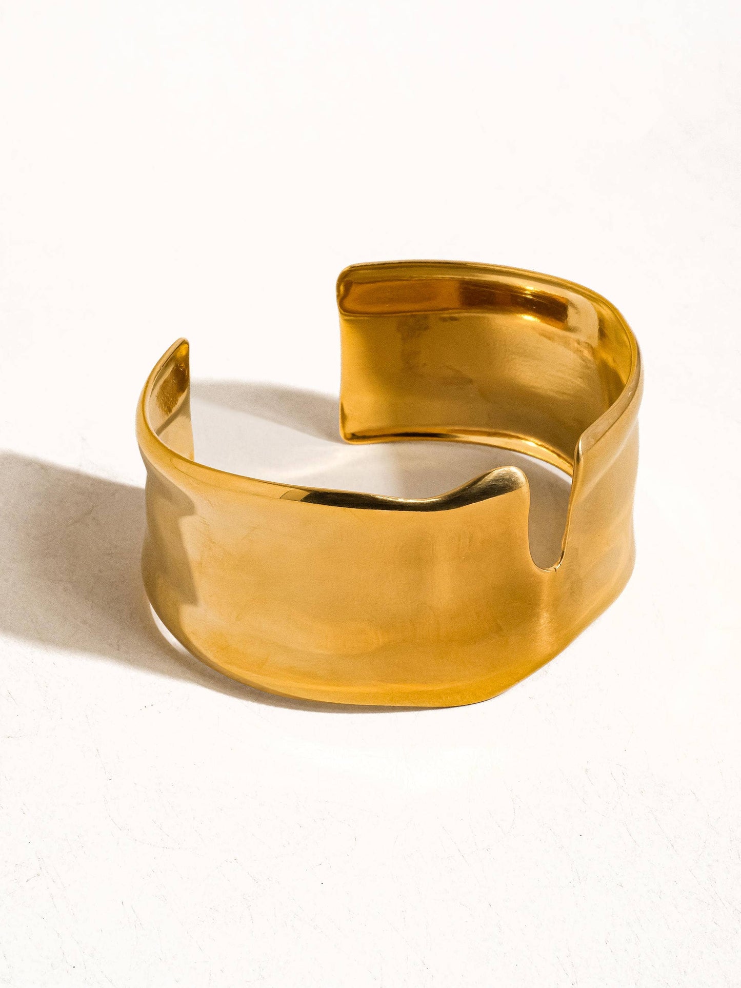 Gold bracelet on a white background