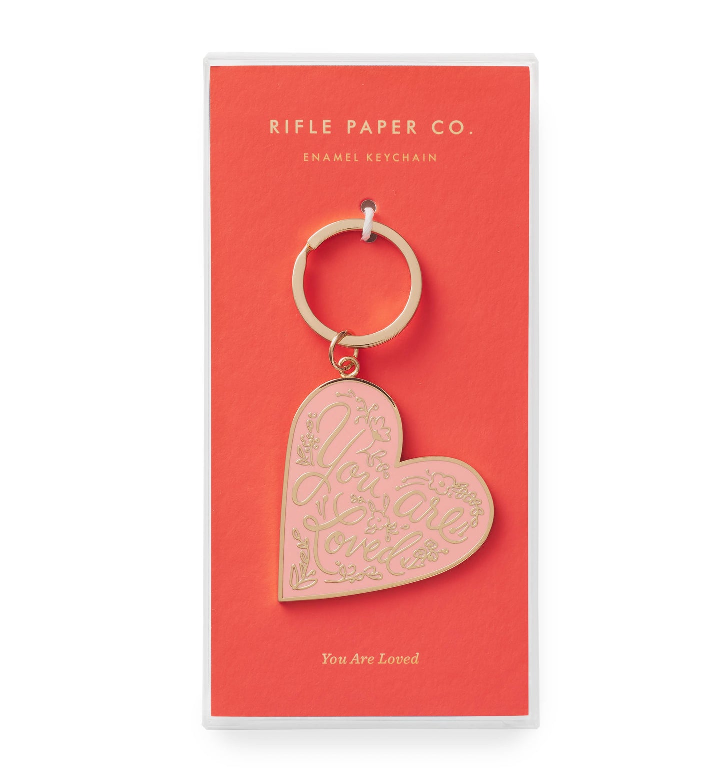 Heart-shaped keychain with 'You Are Loved' text on a Rifle Paper Co. packaging.