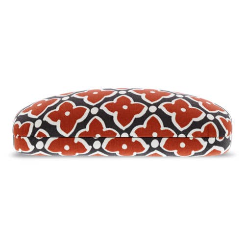 Decorative eyeglass case with red floral pattern on a white background