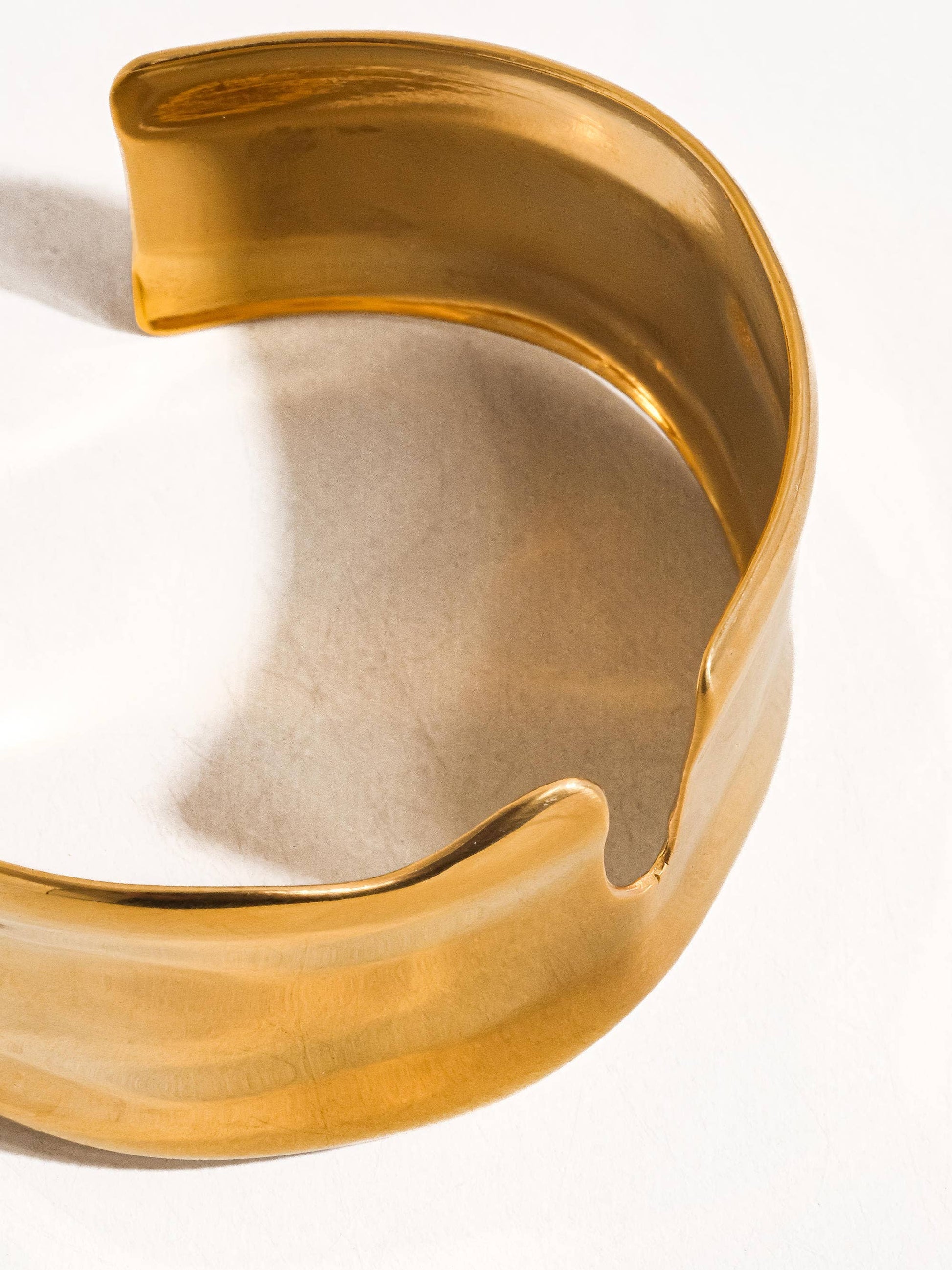 Gold bracelet on a white background