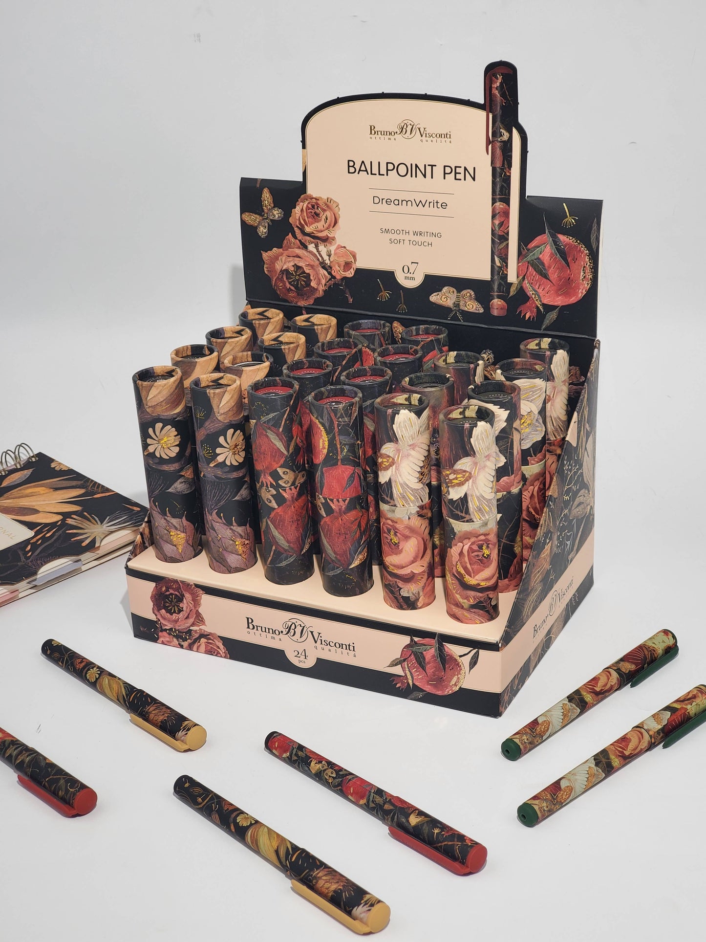 Display of decorative ballpoint pens with floral designs in a branded box.