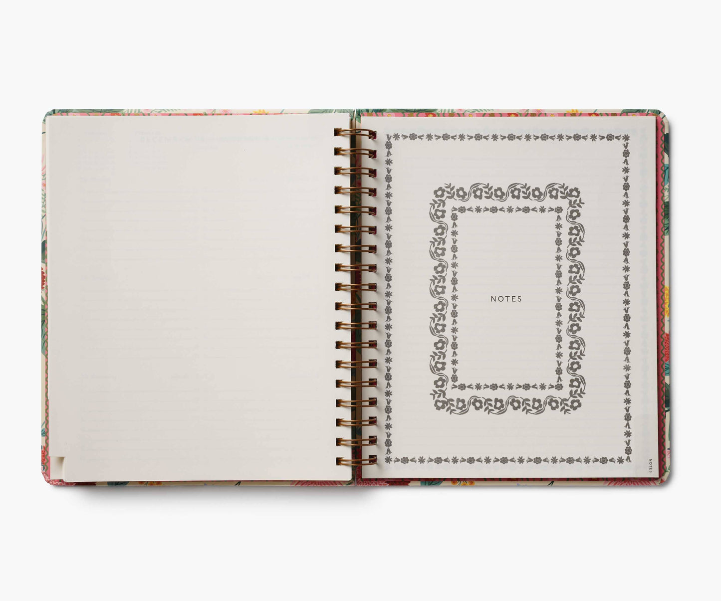 Open notebook with decorative cover and page design on a white background