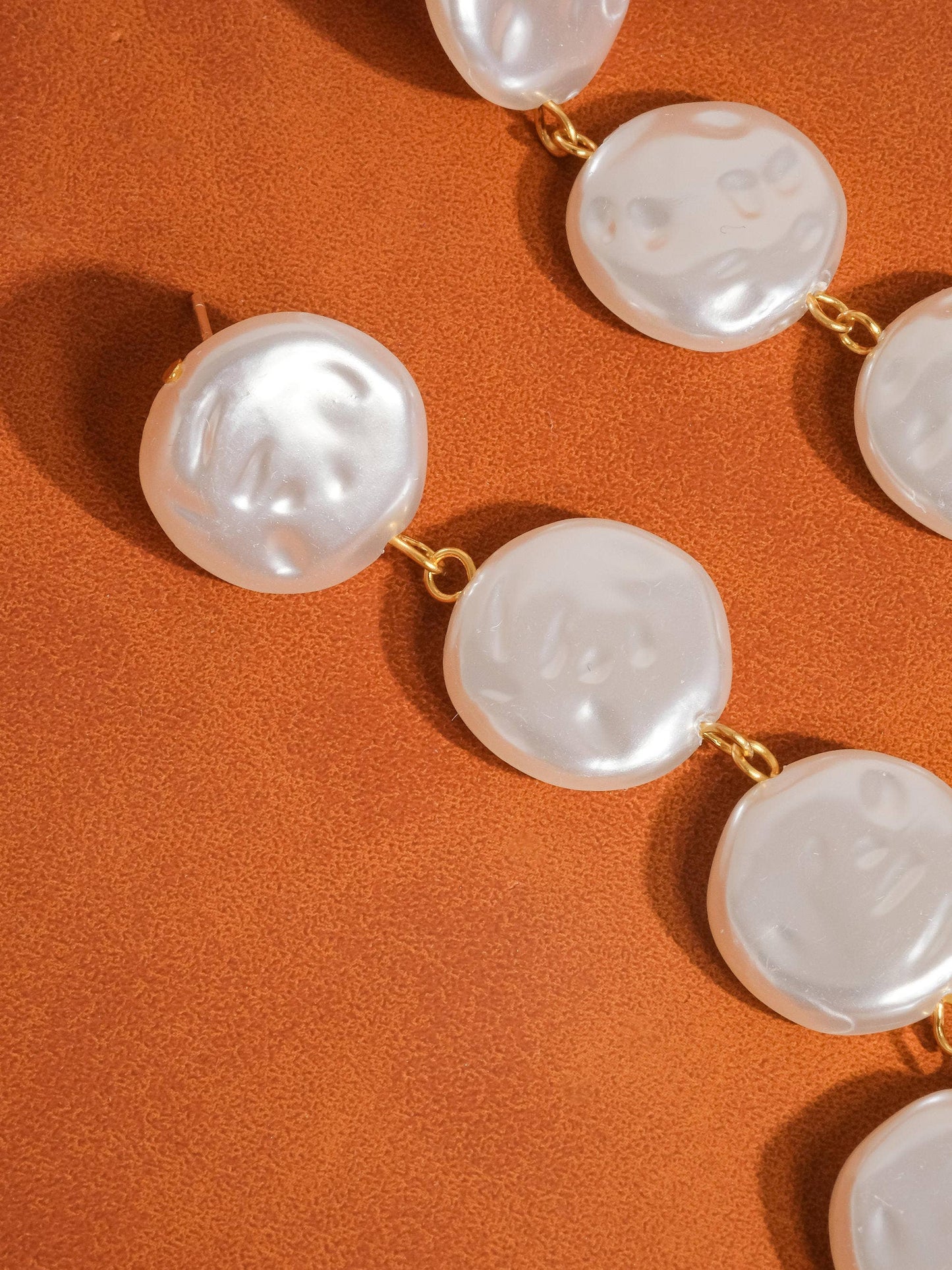 Pearl necklace on an orange background