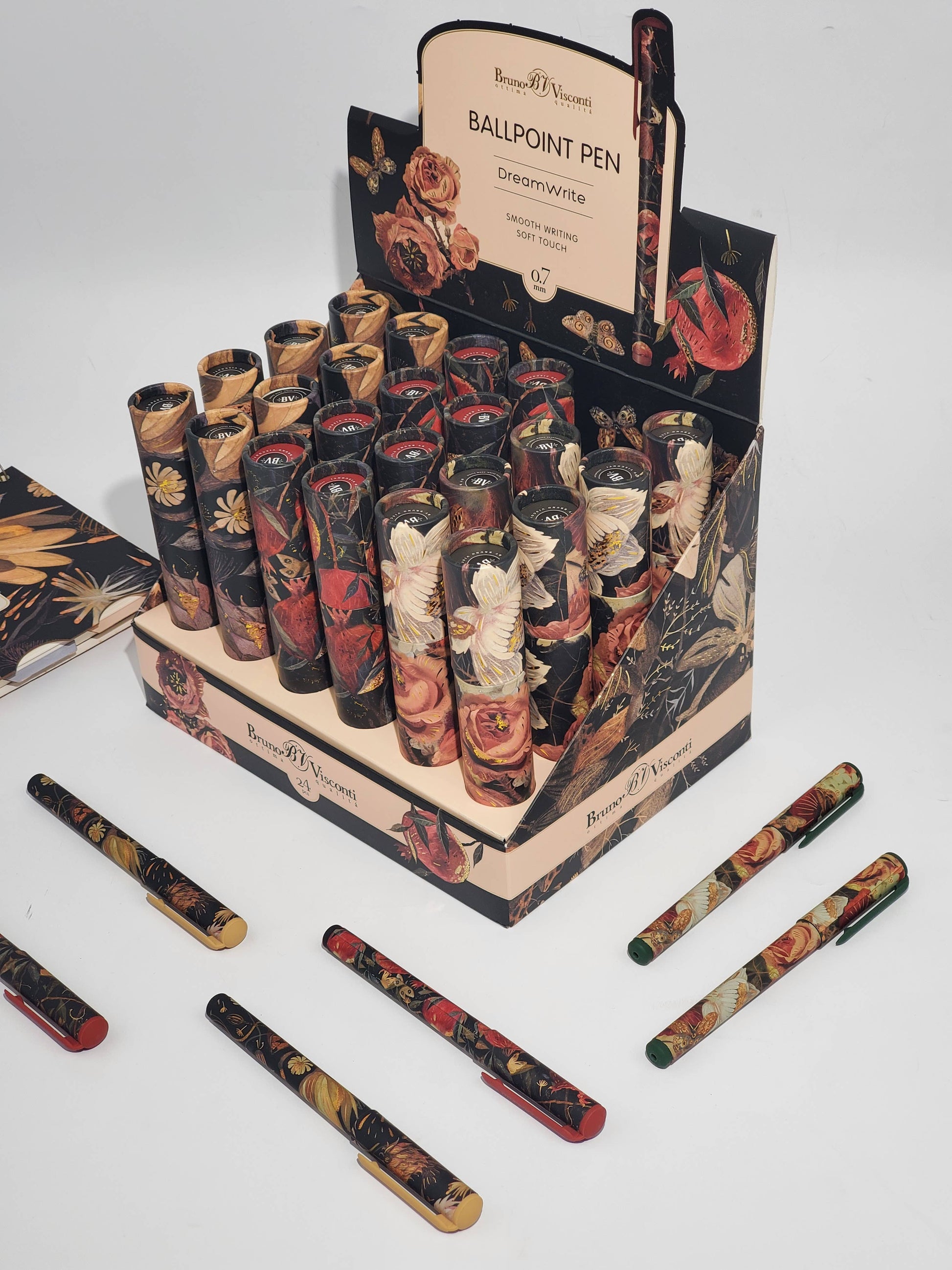 Decorative ballpoint pens in a display box with floral designs on a white background