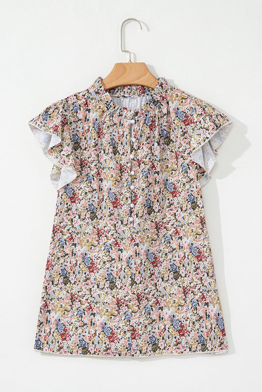 Floral top with ruffled sleeves on a hanger against a white background