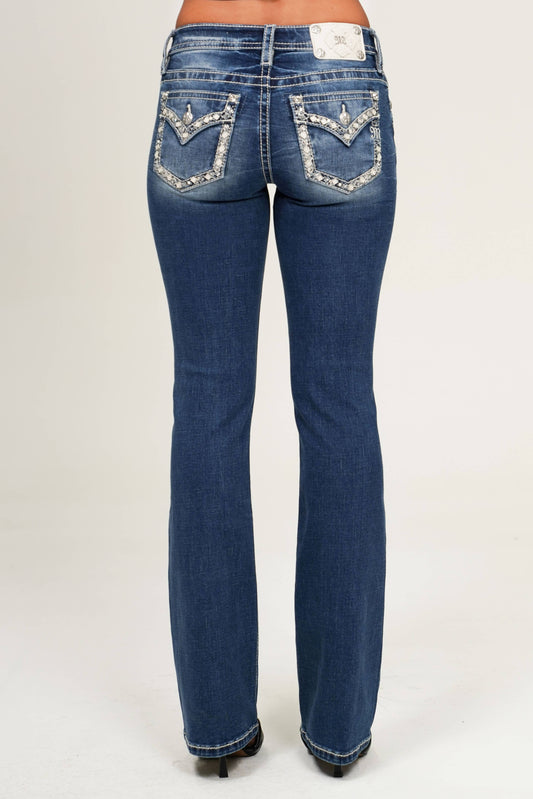 Blue jeans with decorative stitching on a white background