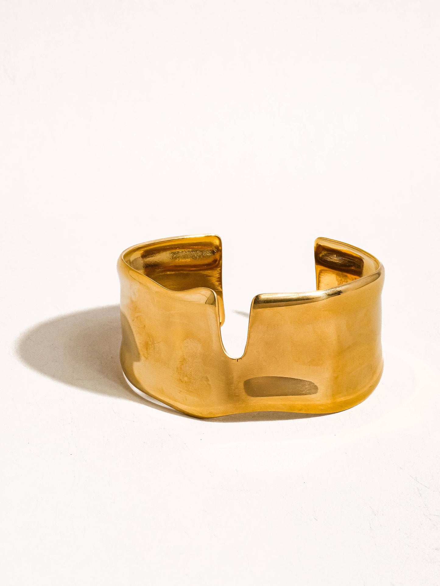 Gold bracelet on a white background