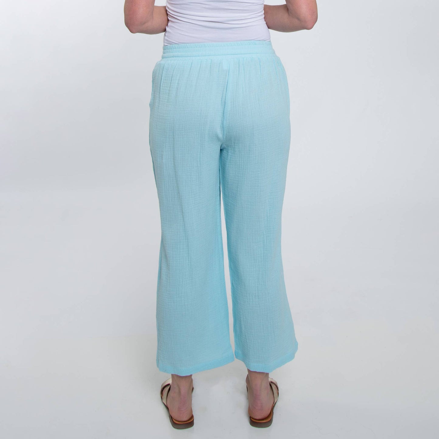 Light blue pants worn by a person on a white background