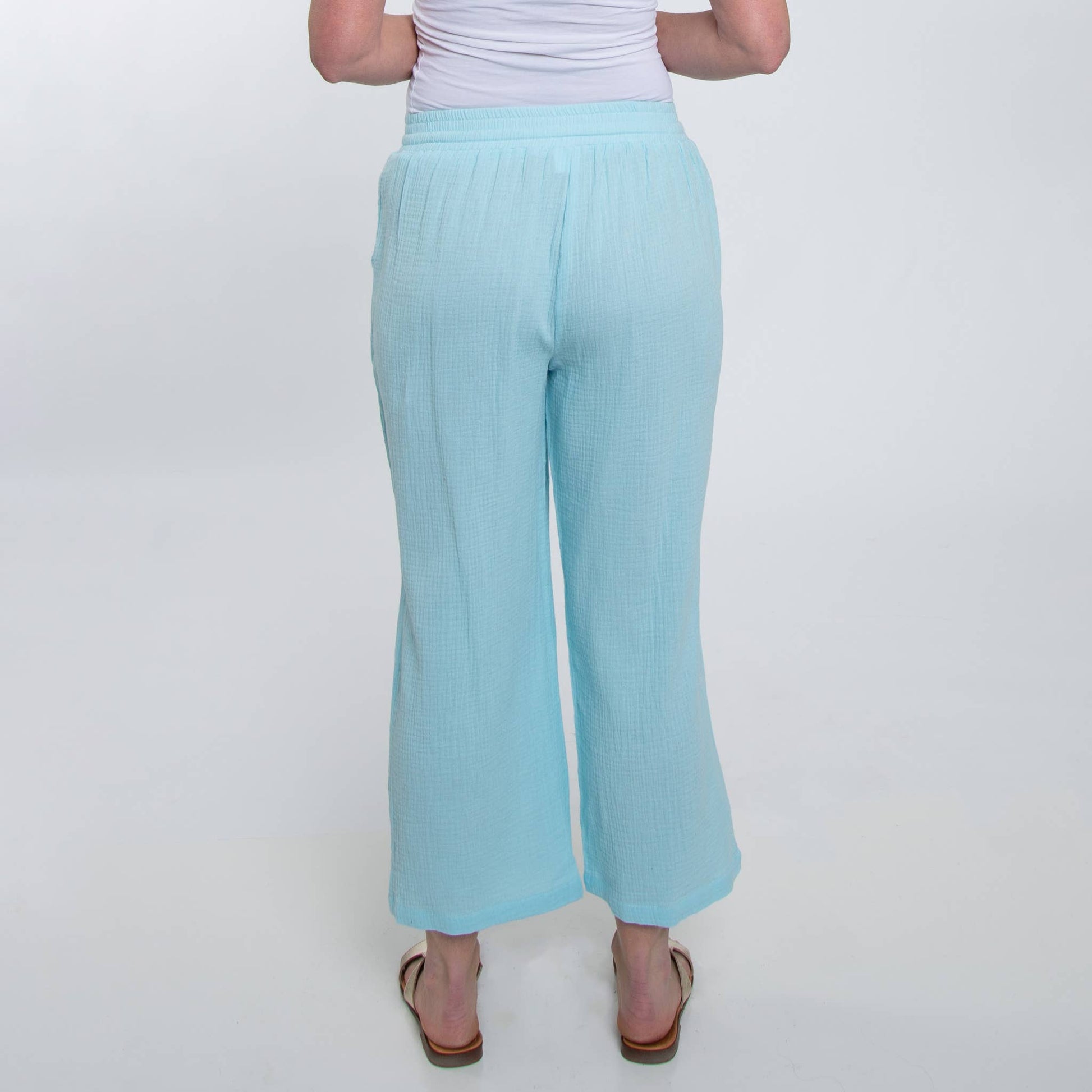 Light blue pants worn by a person on a white background