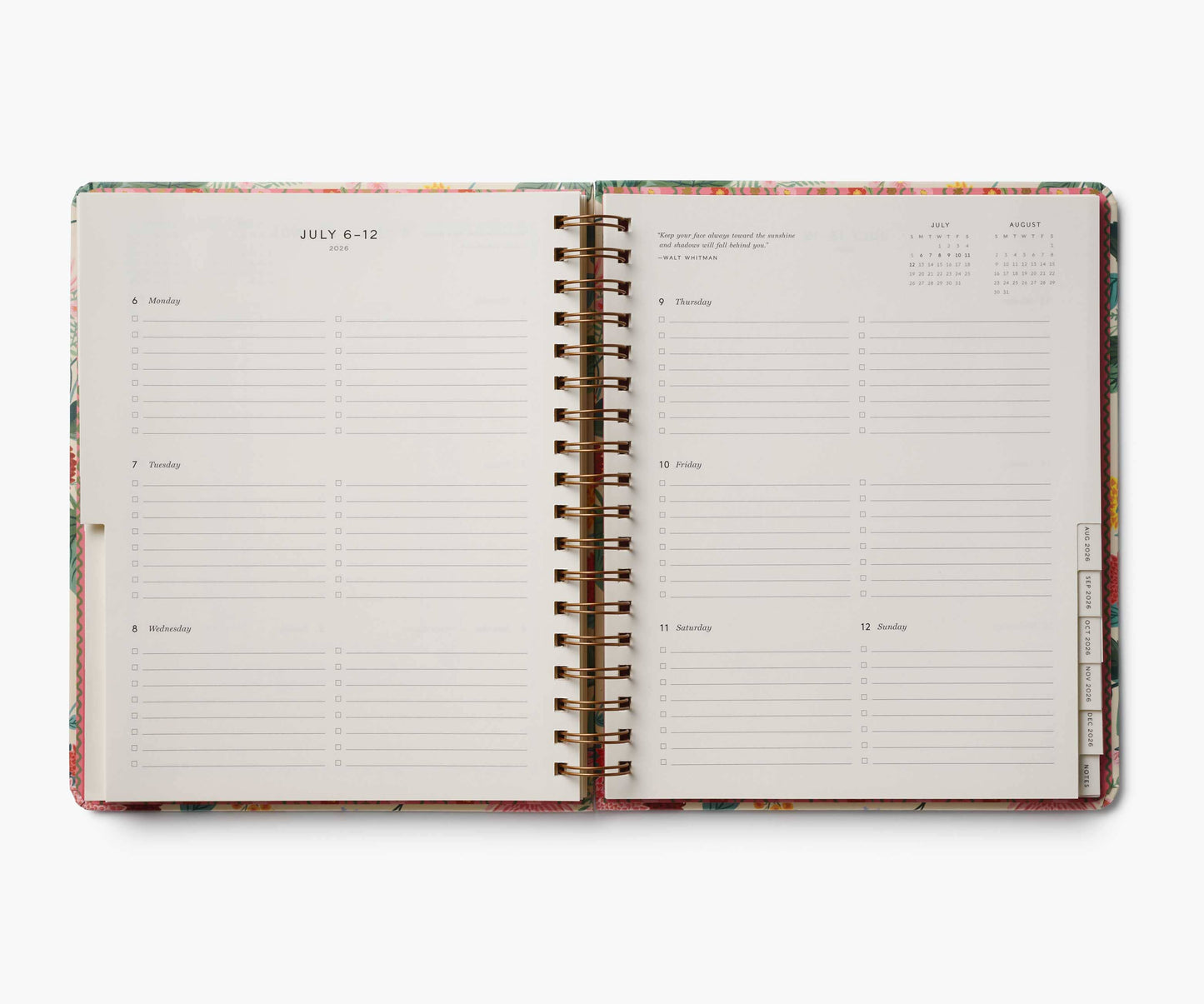Open spiral-bound planner with colorful design on a white background